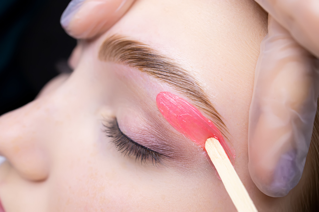 Close-up of Applying Red Wax to Remove Unwanted Hairs from the L